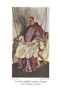 Seated Catholic archbishop in purple episcopal robes and a white lace surplice, wearing a pectoral cross and rings, hands resting on a carved wooden chair against a muted draped backdrop.